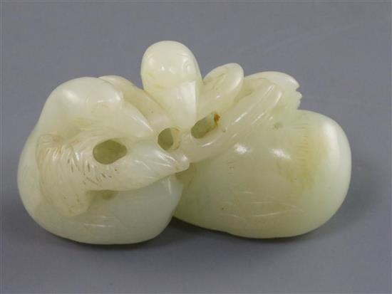 A Chinese pale celadon jade carving of two ducks biting lotus, 19th century L. 5.3cm